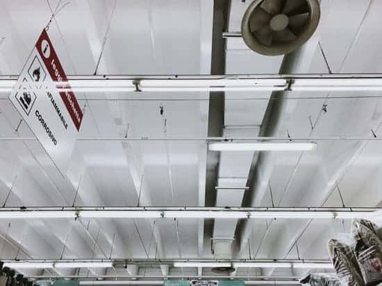 Inside a metal building, looking at the ceiling. There are vents to help keep cool.